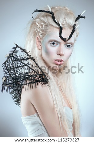 Creative fashion shot with black spikes and crown