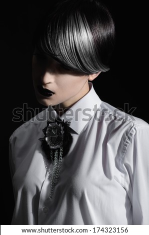 Dark portrait of pale gothic woman with creatively dyed hair