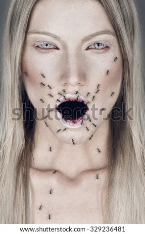 Portrait of blond woman with open mouth and ants
