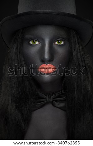 Beautiful portrait of woman in hat with black skin and green eyes