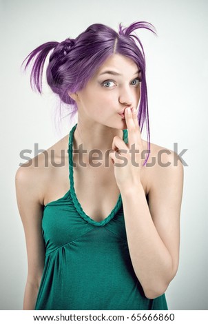 Studio portrait of surprised girl in green outfit with lilac hair