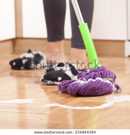 Young woman cleaning and doing housework
