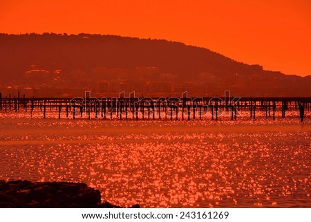 Sun glows red at Bouzigues, in the Herault Department, Languedoc Region of France