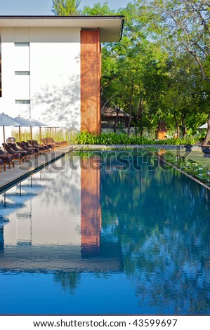 Modern design reflected in a swimming pool in an Asian resort