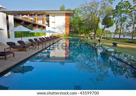 Modern design reflected in a swimming pool in an Asian resort