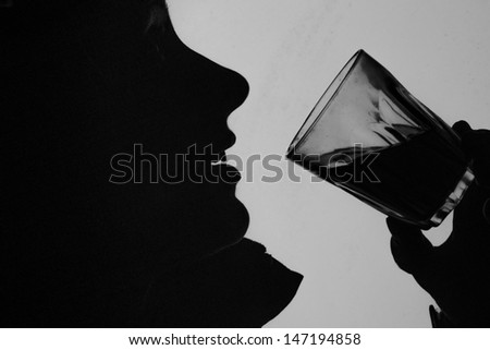 Black and White silhouette of woman drinking a glass of wine