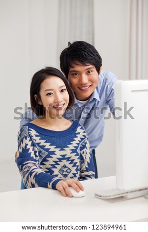 Young Asian couple using PCYoung Asian couple using PC