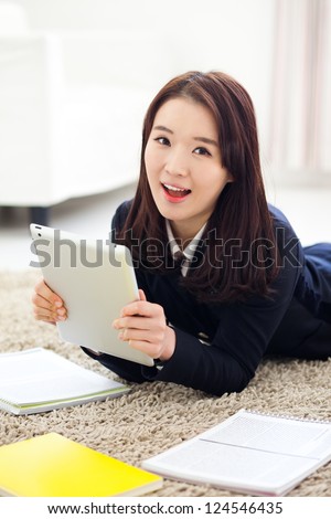Yong pretty Asian student studying  with tablet PC.