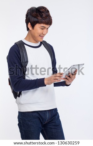 Young Asian student using pad PC isolated on white background.