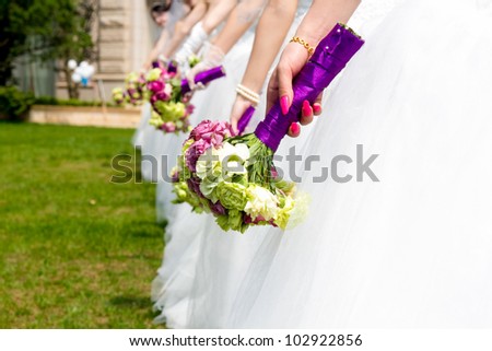 Collective wedding, the bride and holding flowers