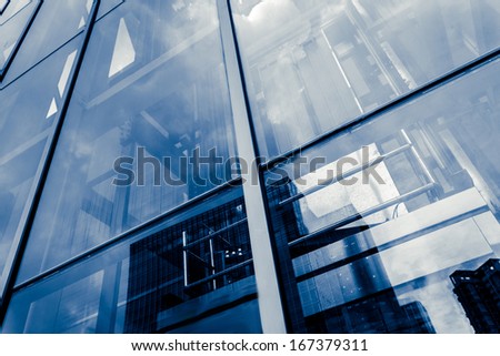 Blue glass wall with small square cells and steel frames