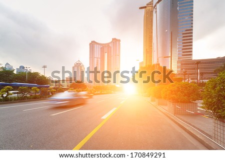 road in city with sunset