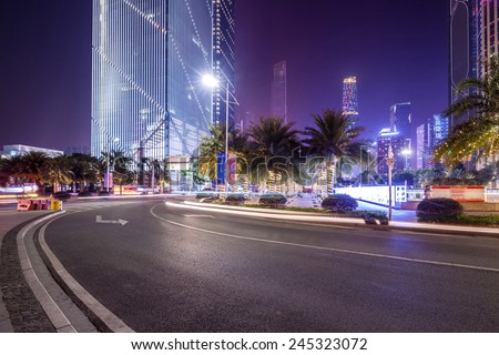 curved light trails on the city road in guangzhou central business district with modern buildings at night