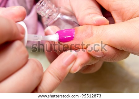 Painting fingers with red nails on white background