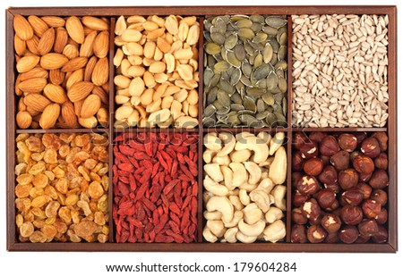 Healthy food organic nutrition.Wooden box full of raw seeds and nuts isolated on white background