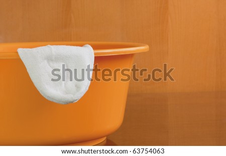 White sock hanging out from a wash basin