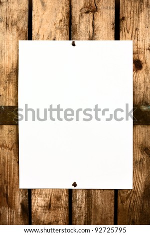 Piece of blank paper tacked to wooden background.Copy space for  text