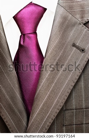 Detail of a men\'s striped business suit.Pink tie and a shirt