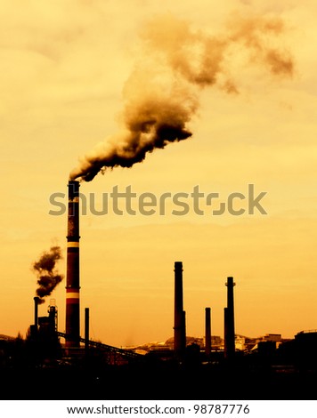 Contrast concept of global warming  in sepia.Pollution smoke from factory