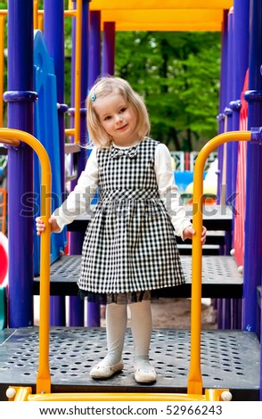 A 3 year old girl in playground equipment