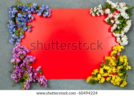 Red paper blank on grey background with flowers design