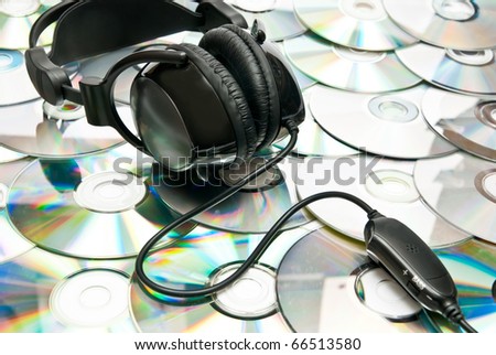 Black headphones on cd background. Studio shot
