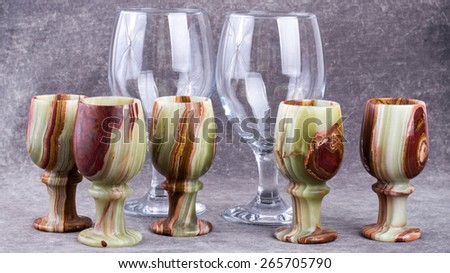 Cups made of natural stone and wine glasses.