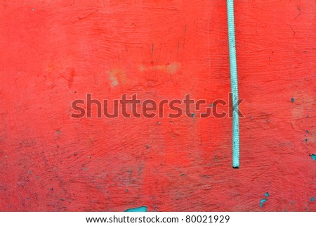red wall with tube of air conditioner