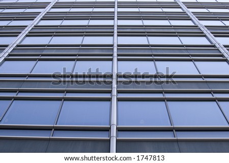 Futuristic abstract shot of the windows of a skyscraper. The lines from the windows are starting to converge to the center.