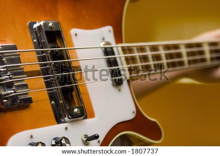 Bass guitar being held and ready to play.