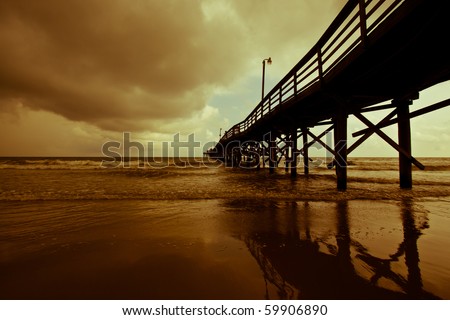 Auburn storm clouds role in over a quiet fishing pier on Myrtle Beach