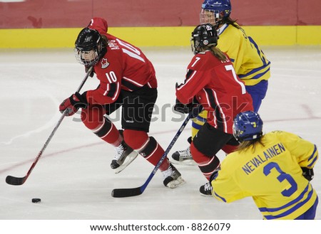 stock-photo-women-s-olympic-ice-hockey-competition-at-the-winter-olympics-in-turin-italy-sweden-v-canada-8826079.jpg