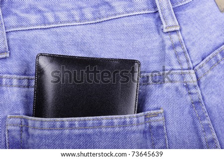 Thick leather wallet in back pocket of a pair of jeans.