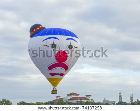 PUTRAJAYA, MALAYSIA-MAR 19:Clown face balloon from Belgium in flight at the 3rd Putrajaya International Hot Air Balloon Fiesta Mar 19, 2011 in Putrajaya.27 International balloonist in this year event