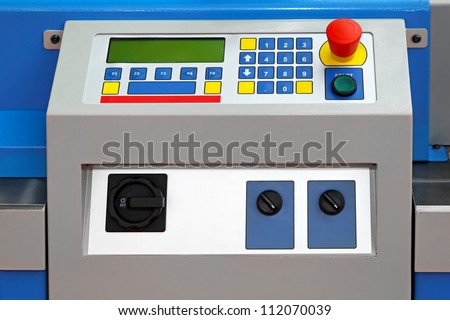 Control panel with panic stop button at machine