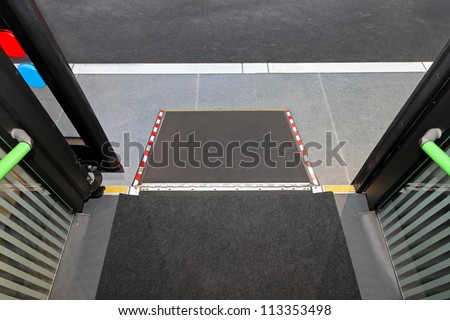 Retractable ramp for wheelchair at city bus