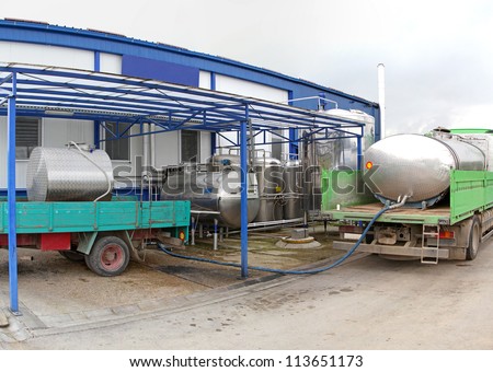 Unloading raw milk from trucks in dairy factory