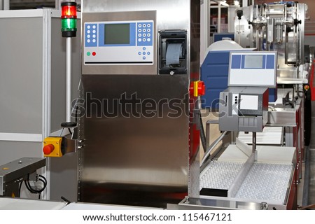 Modern packaging machine at production line in factory