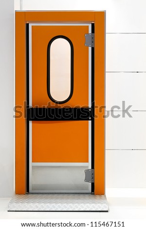 Insulated orange door at industrial fridge reefer