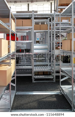 Metal shelving system with boxes in storehouse