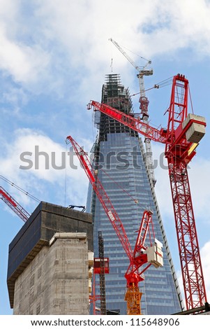 Red cranes at construction site of The Scard tower