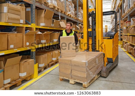 Order Picking Worker With Box in Fulfillment Warehouse