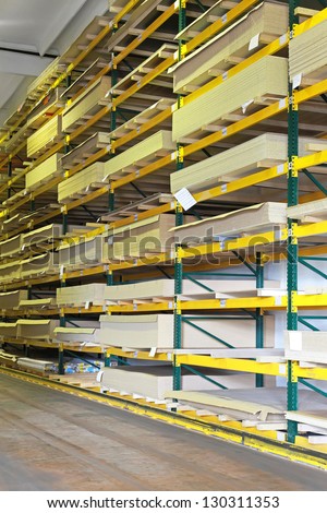 Shelf with wood and building materials in warehouse