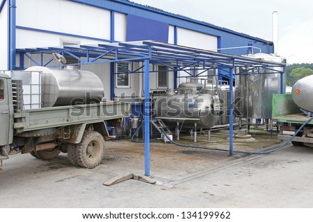 Unloading raw milk from trucks in dairy factory
