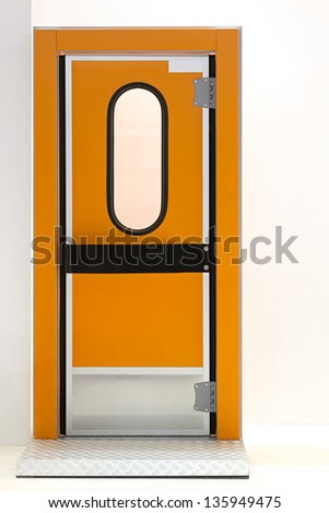 Orange insulated door at industrial fridge reefer