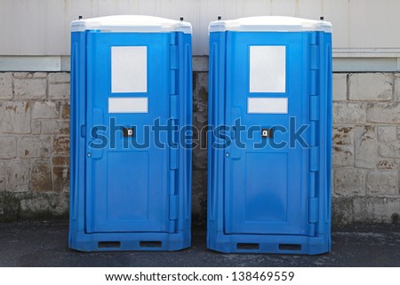 Two portable toilet cabins at construction site