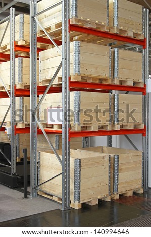 Wooden shipping boxes with pallets in warehouse shelving