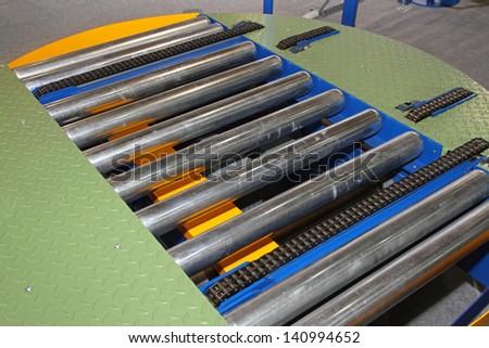 Conveyor rollers for moving goods through factory line