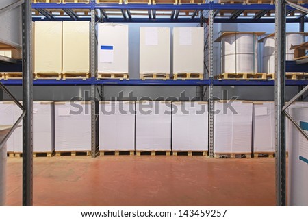 Pallets with printing paper in distrbution warehouse