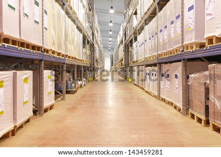 Long corridor with shelves in distribution warehouse